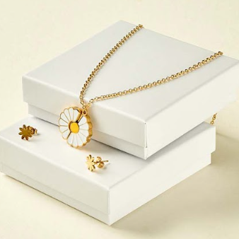 Gold necklace with a sunflower pendant on a white stand